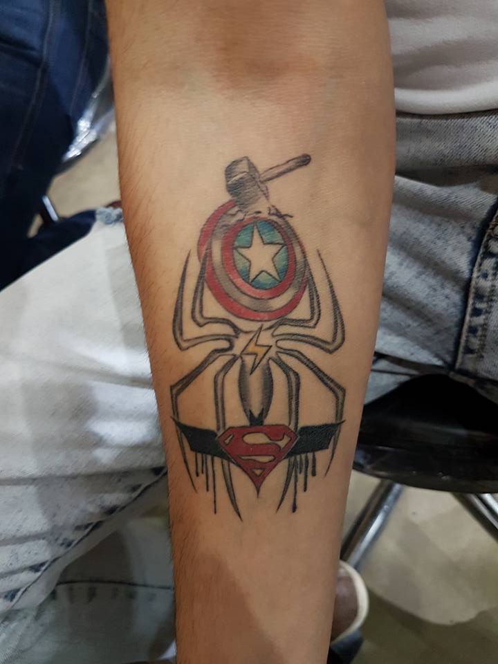 Superman Logo And Spider Tattoo On Forearm by KDZ Tattoos