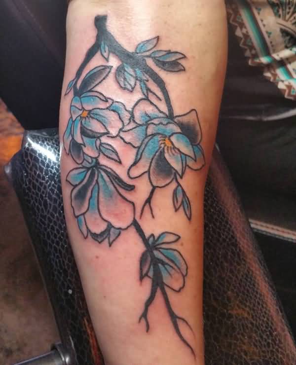 Black And Blue Magnolia Flower Tattoos On Arm