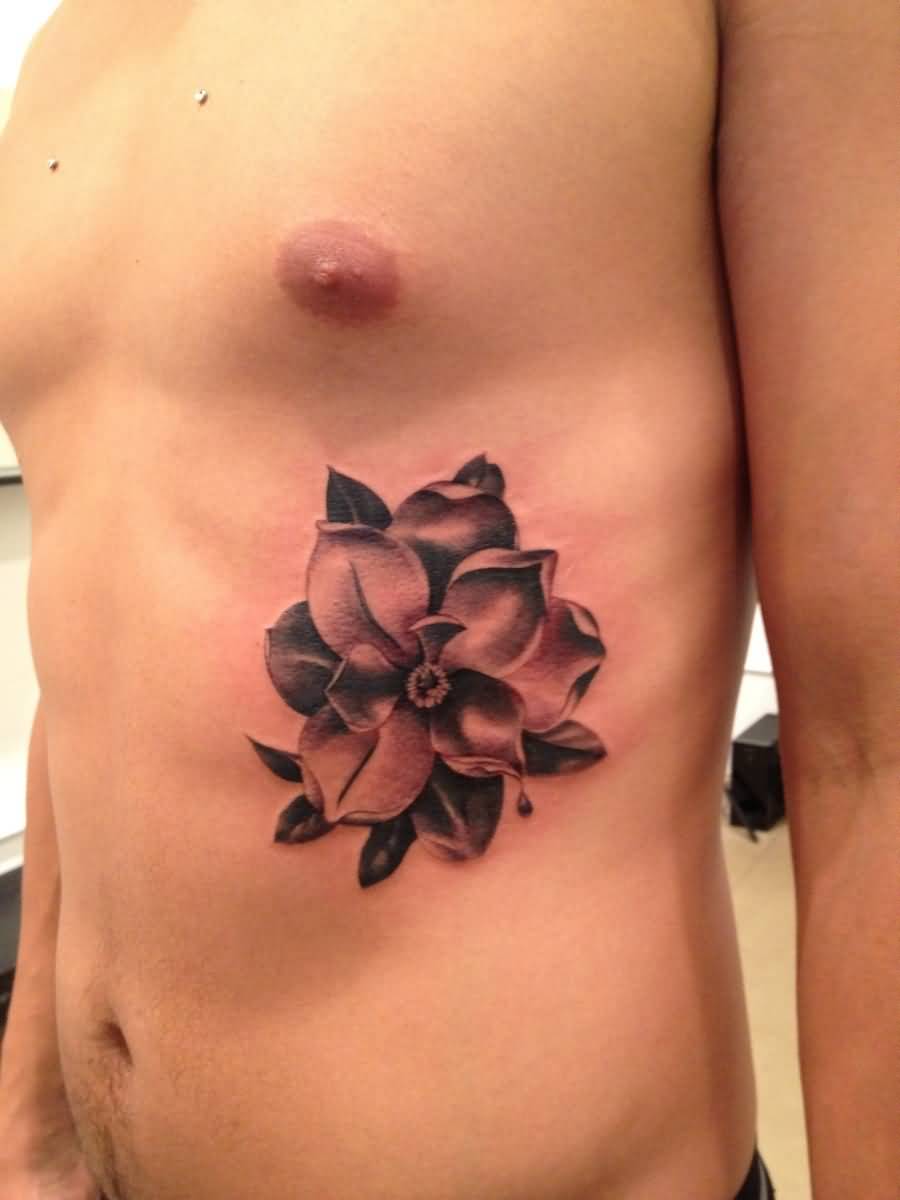 Black And Grey Magnolia Tattoo On Man Side Rib