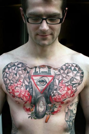 Crazy abstract elephant chest tattoo with three eyes