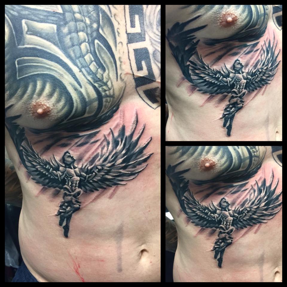 Flying angel tattoo on lower chest by Levi Bell