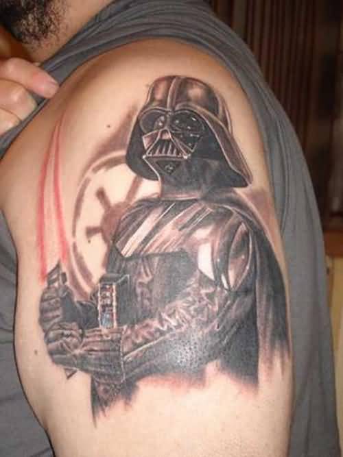 Man Showing His Darth Vader Helmet Tattoo On Shoulder