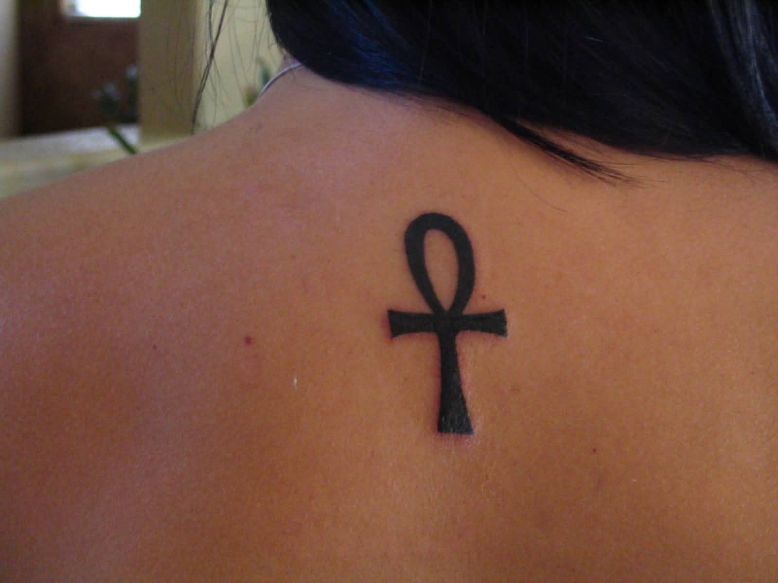 Black Ankh Tattoo On Girl Upper Back