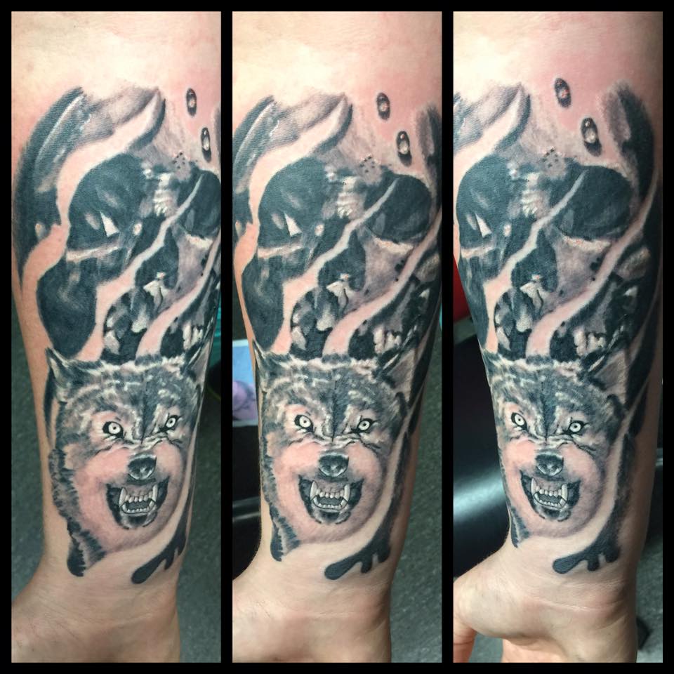 Black and White Wolf Tattoo on Wrist by Levi Bell