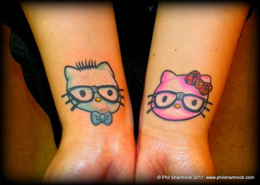 Blue And Pink Hello Kitty Tattoos On Wrist