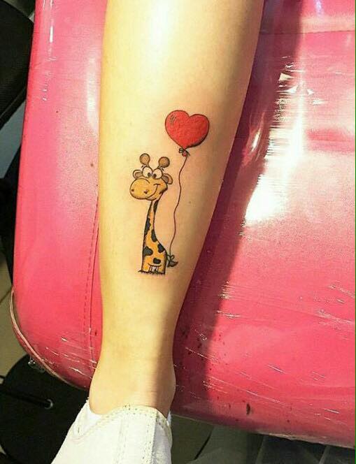 Cartoon Giraffe With Heart Balloon Tattoo On Leg