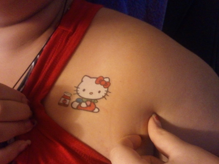 Color Hello Kitty Tattoo On Front Shoulder.