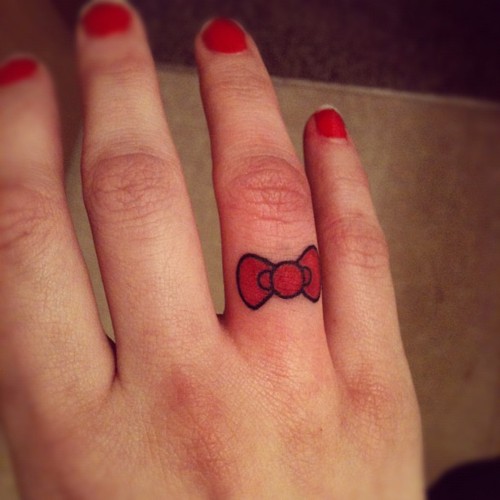 Cute Hello Kitty Bow Tattoo On Finger