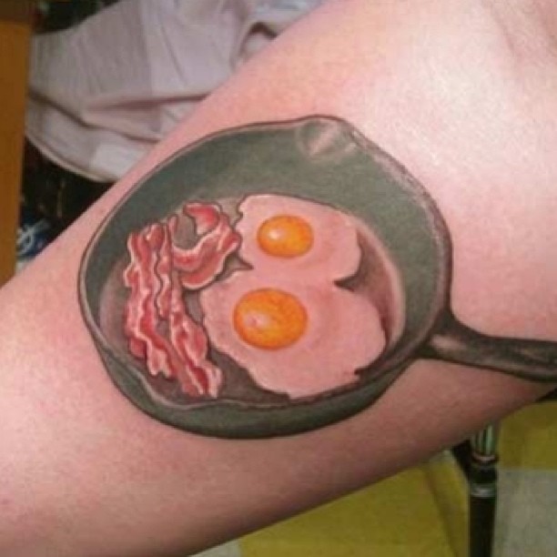 Egg Yolks And Bacon In Pan Tattoo On Arm