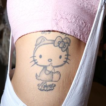 Grey And White Hello Kitty Tattoo On Girl Side Rib