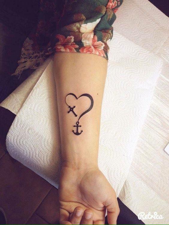 Heart With Anchor And Cross Tattoo On Girl Left Forearm