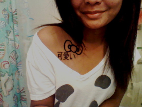 Hello Kitty Bow Tattoo On Girl Front Shoulder