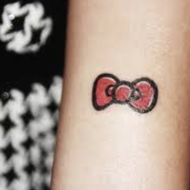 Hello Kitty Bow Tattoo On Left Forearm