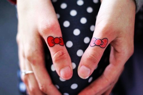 Hello Kitty Bow Tattoos On Both Thumbs