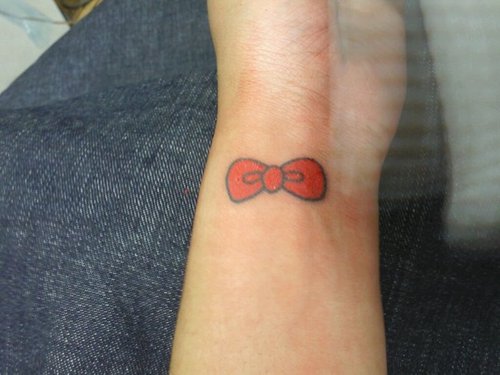Hello Kitty Red Bow Tattoo On Wrist