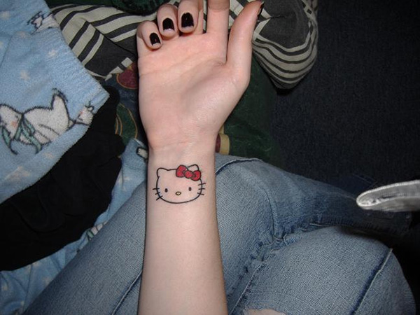 Hello Kitty With Red Bow Tattoo On Wrist
