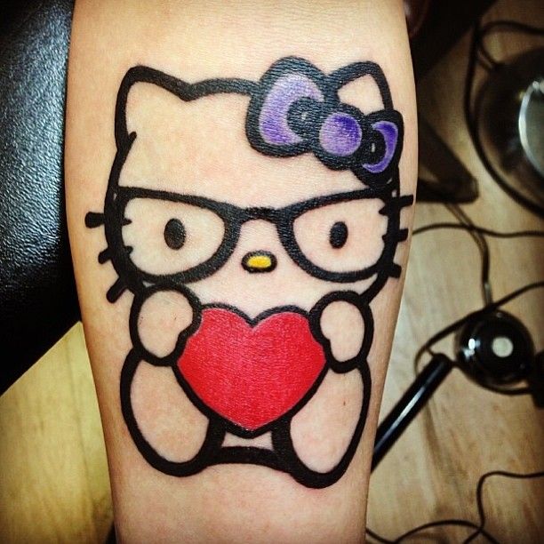 Hello Kitty With Red Heart Tattoo On Forearm