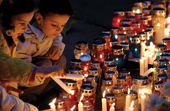 Kids Lighting Candles During All Saints Day Celebration