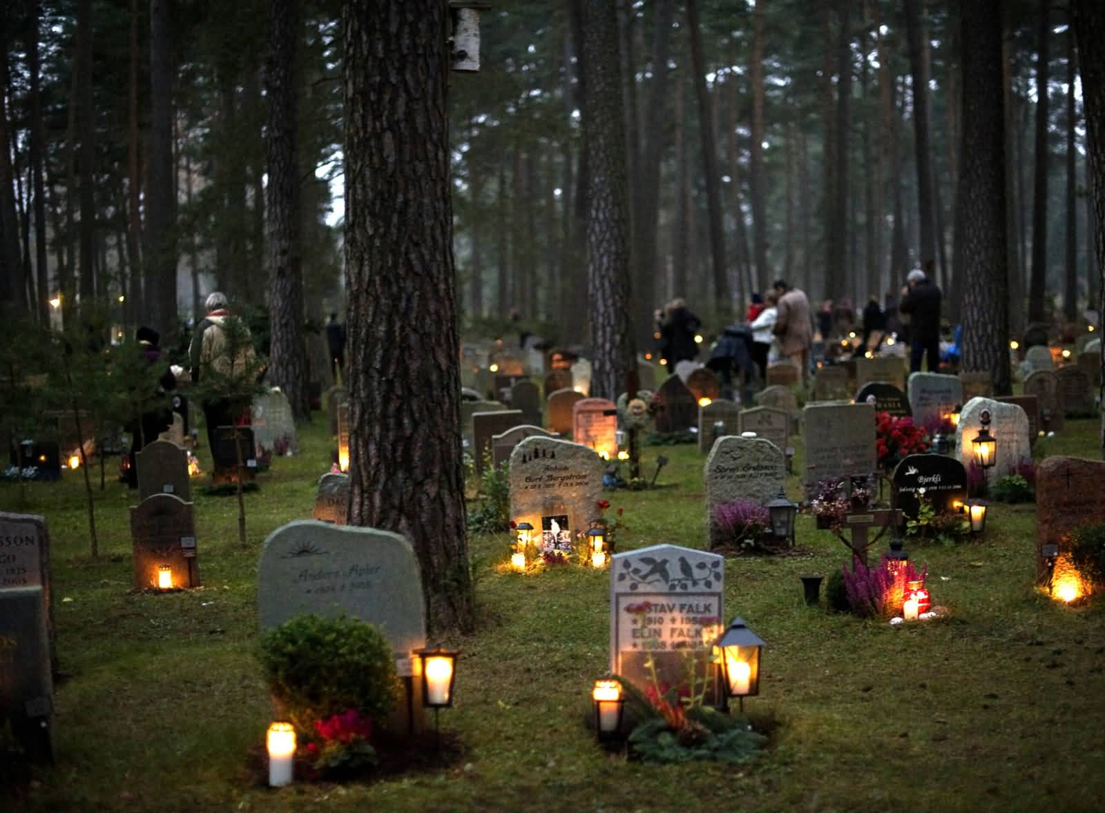 Lighting Candles At Graves During All Saints Day Celebration