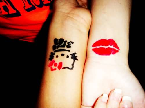 Lip Print And Hello Kitty Tattoos On Wrist