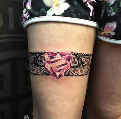 Pink Heart Gem Garter Tattoo On Thigh
