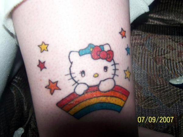 Rainbow With Hello Kitty Bow Tattoo On Sleeve