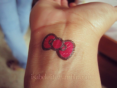 Red Bow Of Hello Kitty Tattoo On Wrist