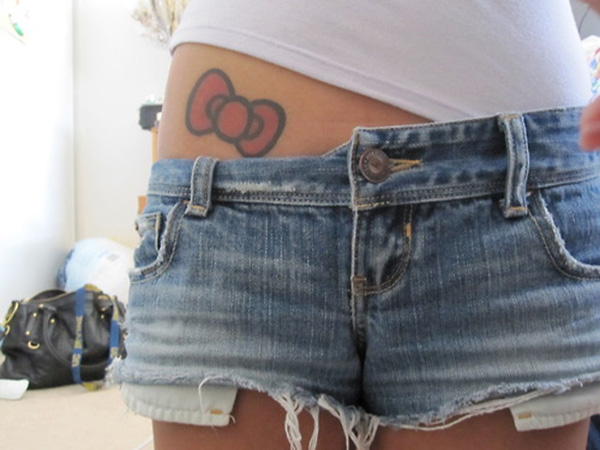 Red Hello Kitty Bow Tattoo On Girl Right Hip