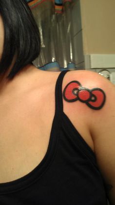 Red Hello Kitty Bow Tattoo On Left Shoulder