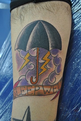 Sleep Well Banner And Umbrella Tattoo On Leg