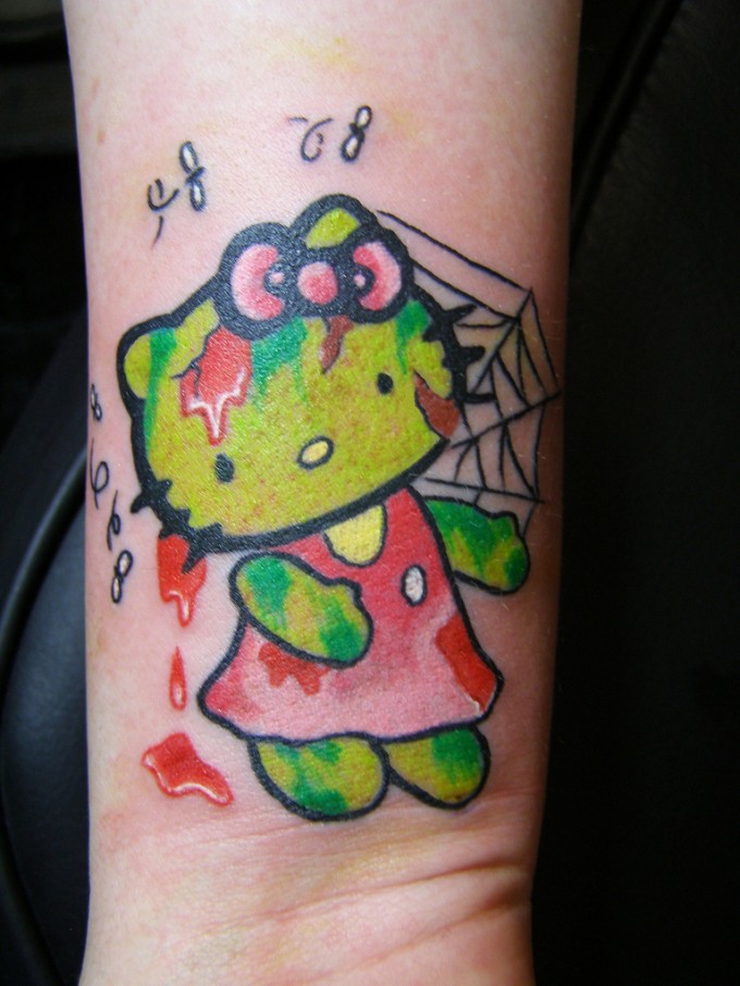 Spider Web And Zombie Hello Kitty Tattoo On Forearm