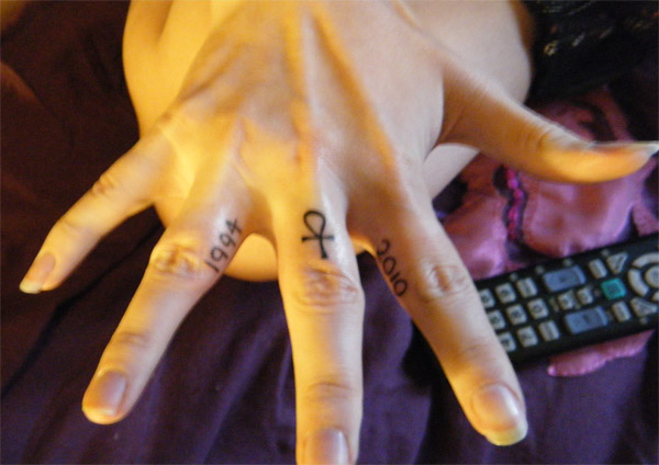 Tiny Ankh Tattoo On Finger