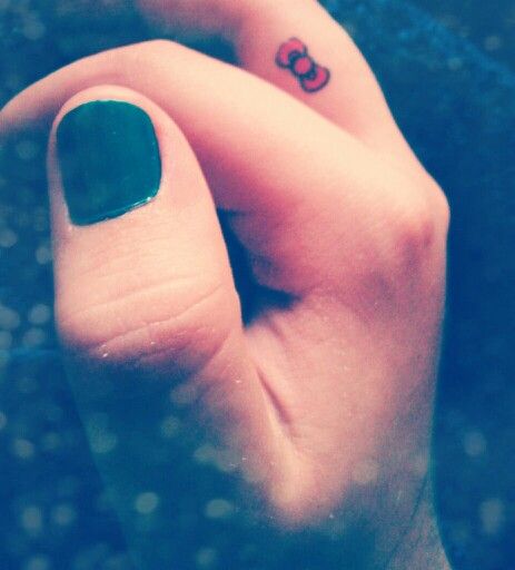 Tiny Hello Kitty Bow Tattoo On Finger