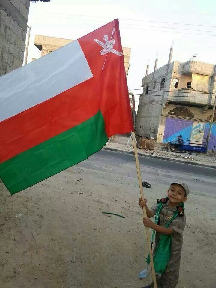 A Little Boy Waving Omani Flag Ahead Of National Day Of Oman