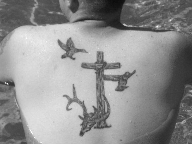 Cross And Flying Duck Tattoos On Upper Back