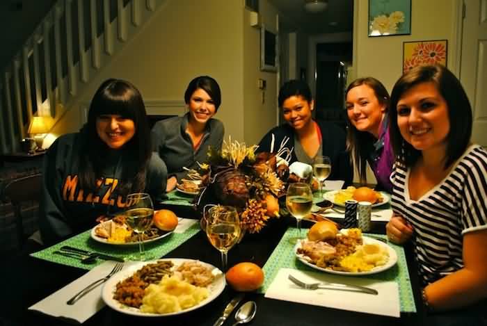Friends Enjoying Dinner During Thanksgiving Day Celebration