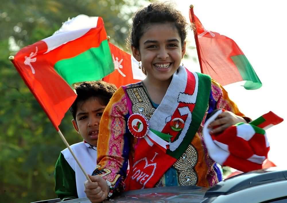 Girl With Oman Flags In Hand During National Day Celebration Picture