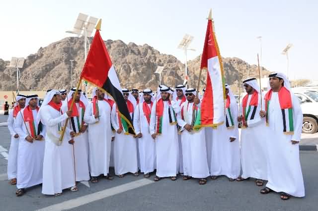 People Of Oman Celebrating National Day With Flags In Hand