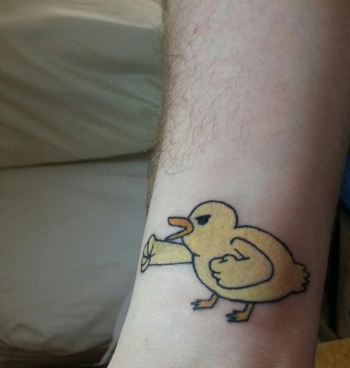 Small Yellow Ink Duck Tattoo On Leg