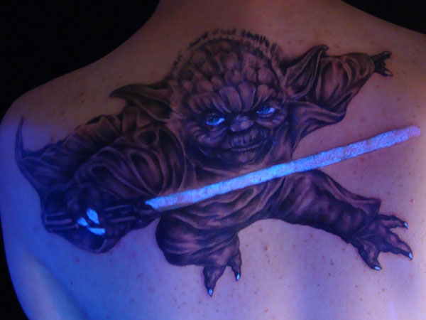 Black Light Yoda Tattoo On Upper Back