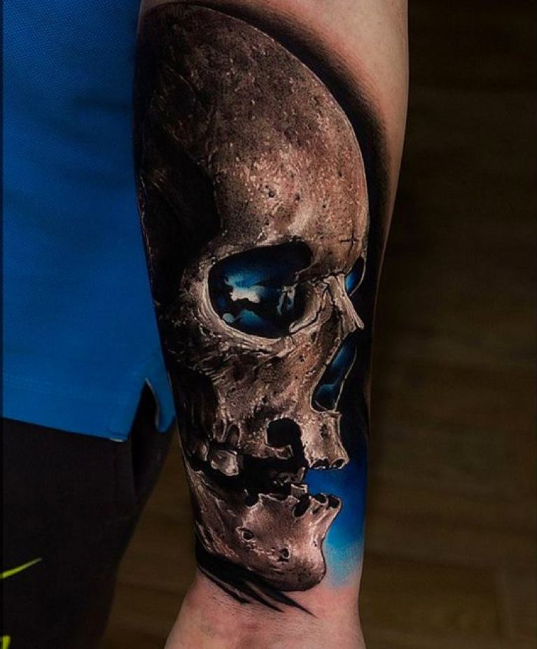 Blue Eyes Skull Tattoo On Left Arm