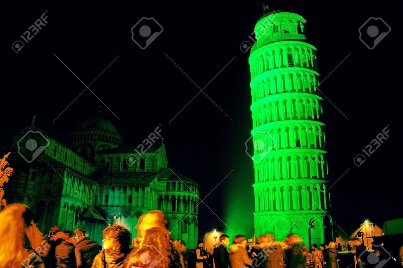 The Leaning Tower Of Pisa Is Colored With Green Light At Night