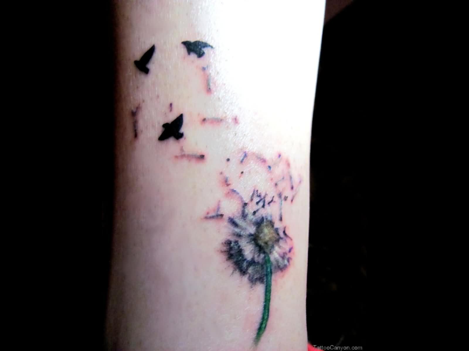 Birds Blowing From Dandelion In Colorful Ink Tattoo On Wrist