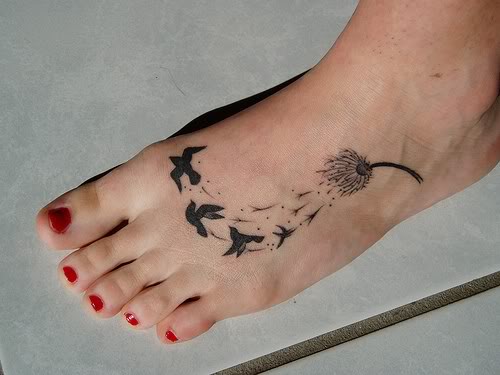 Birds Flying From Dandelion In Deep Black Ink Tattoo On Foot