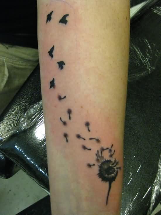 Birds Flying From Dandelion In Deep Black Ink Tattoo On Wrist