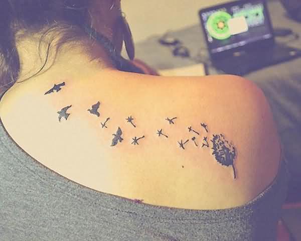 Birds In Black Ink Blowing From Dandelion Tattoo On Back Shoulder From Back Neck
