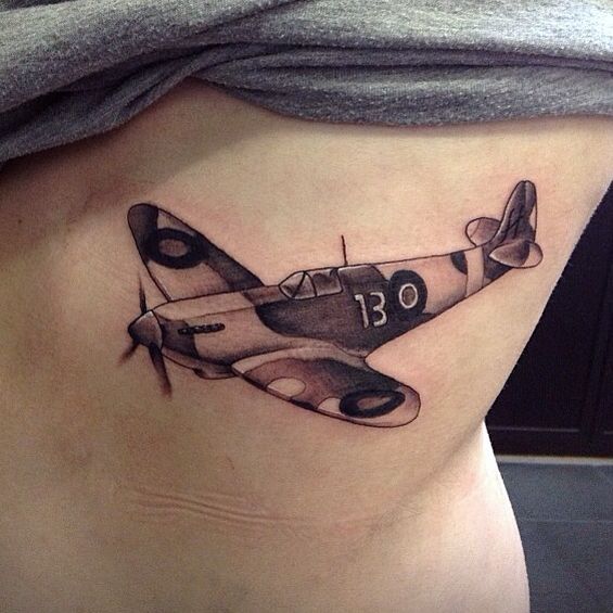 Black And Grey Spitfire Tattoo On Side Rib by Greg Scott