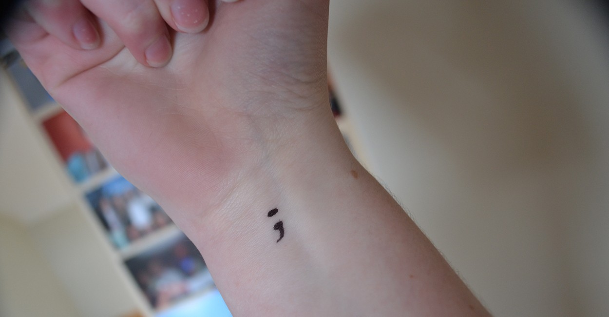 Black Ink Semicolon Tattoo On Right Wrist