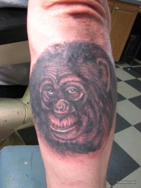 Chimpanzee Head Tattoo On Left Arm