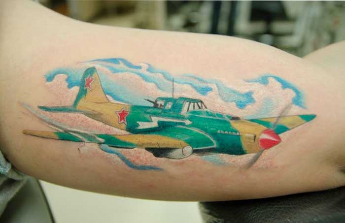 Colored Spitfire Tattoo On Muscles